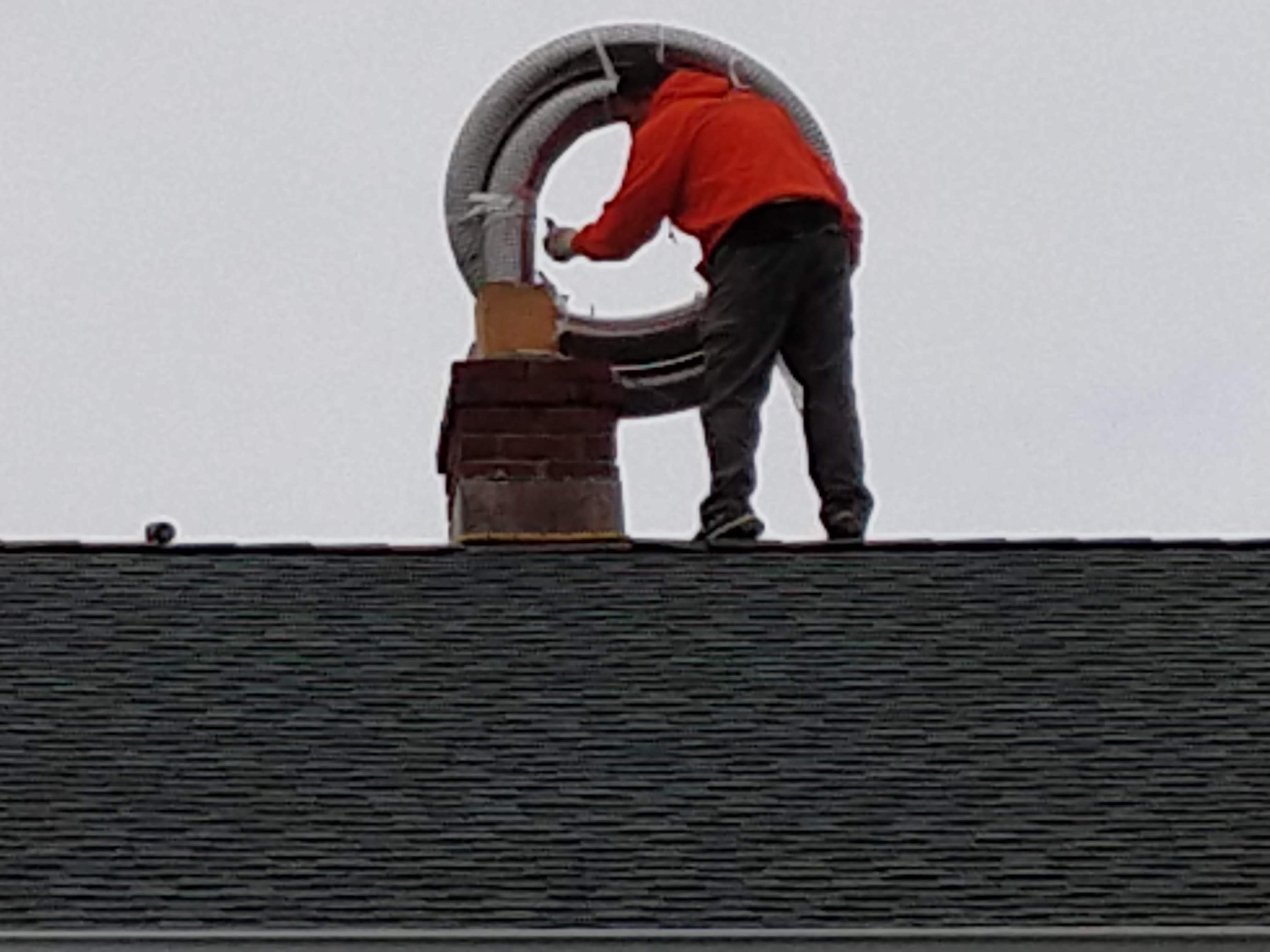Flexible stainless chimney liner being installed in Freeport, New York